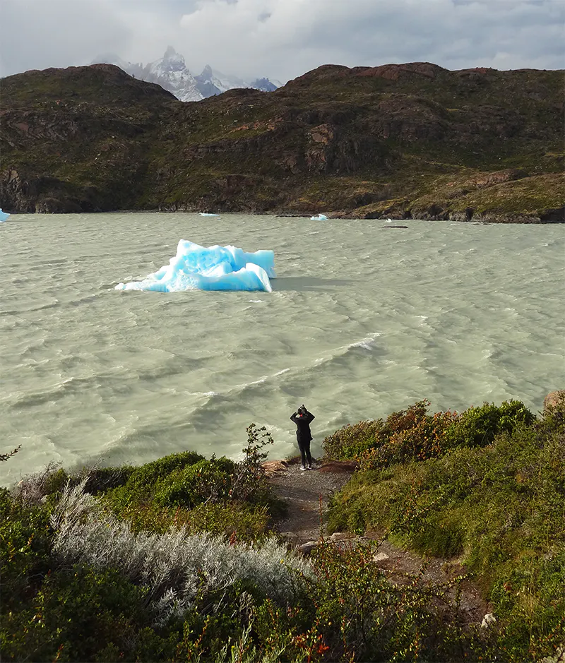 Viajera observando icebegrs en lago de Torres del Paine