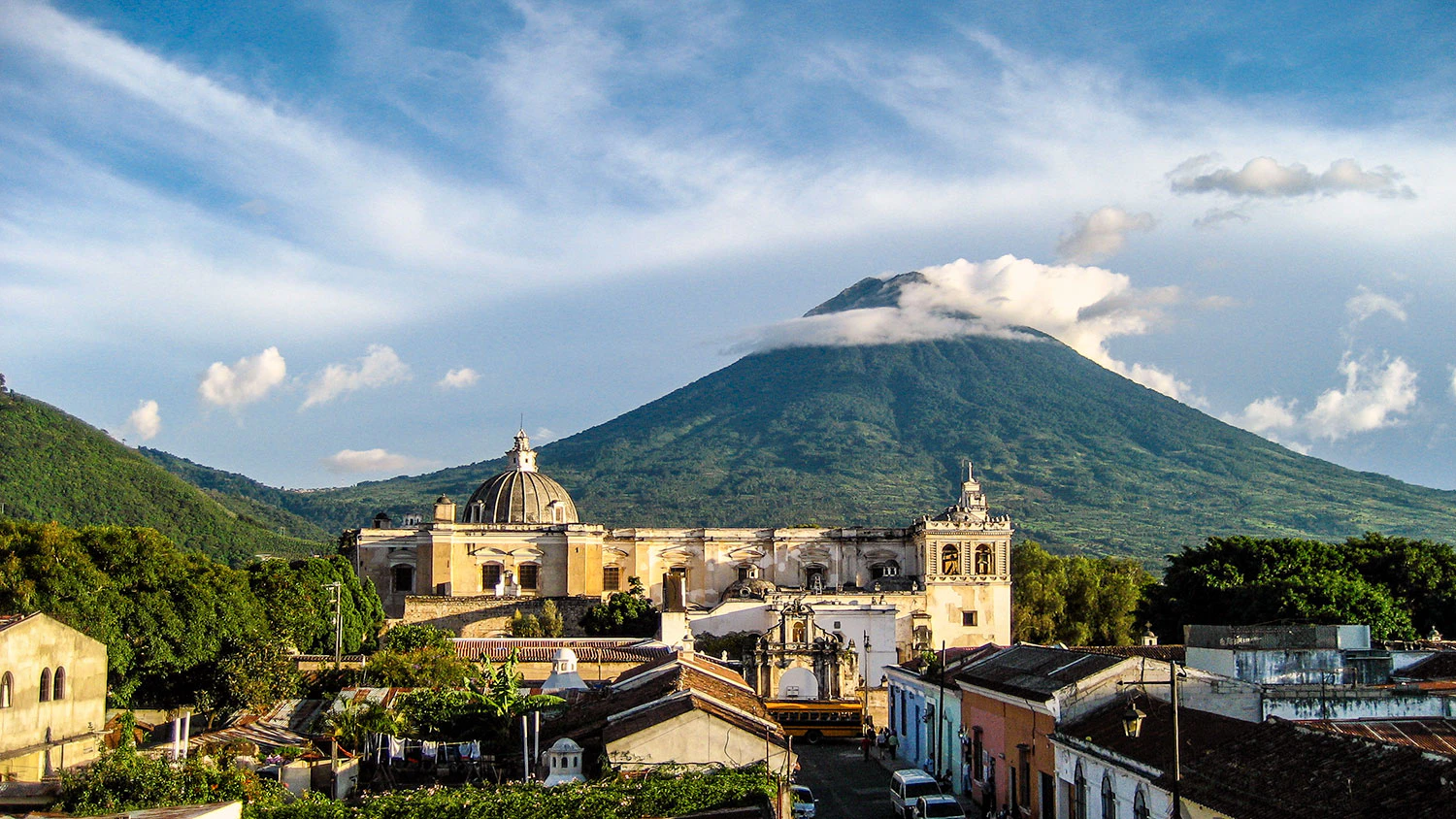 Ciudad colonial con gran volcan en el fondo